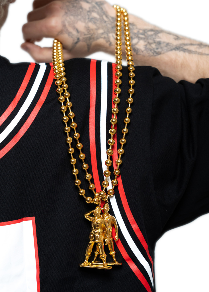 Gold plated LNA soldier chain worn over a black and red jersey