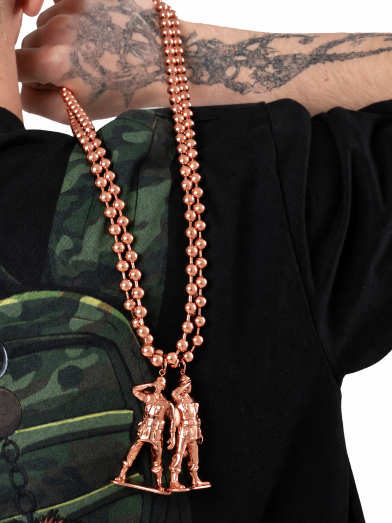 Rose gold plated soldier chain worn over a black tee with a camo graphic
