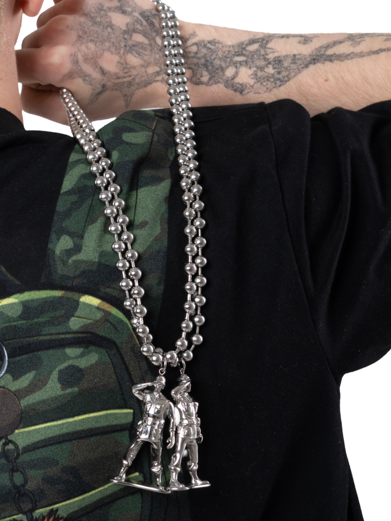 Stainless steel LNA soldier chain worn over a black tee
