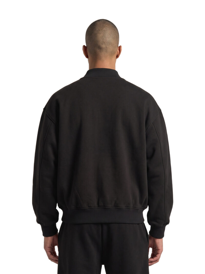 Offside Homecoming Varsity Jacket in black, worn by model